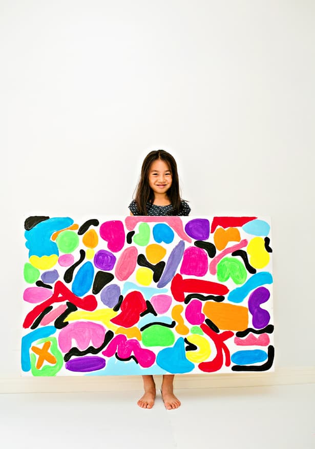 kid painting on canvas